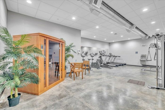 State-of-the-Art Fitness Center at Sixty16 Apartments Shawnee, KS: Interior view of the state-of-the-art fitness center at Sixty16 Apartments in Shawnee, KS, offering modern exercise equipment and amenities.
