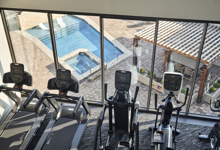 24-Hour Fitness Studio with pool and couryard views at The Lofts at City Center