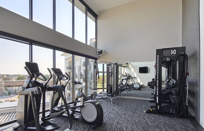 Modern fitness center with cardio and strength equipment at The Lofts at City