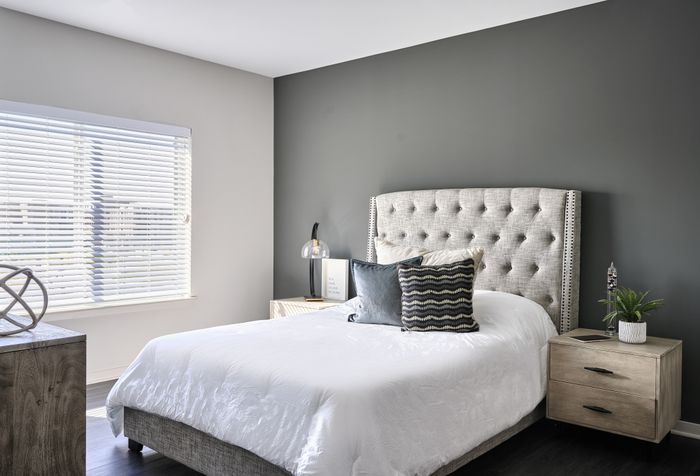 Spacious bedroom with modern furniture and ample natural light