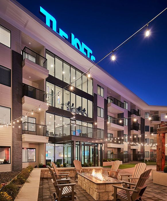 The Lofts at City Center exterior at night with illuminated facade and balconies