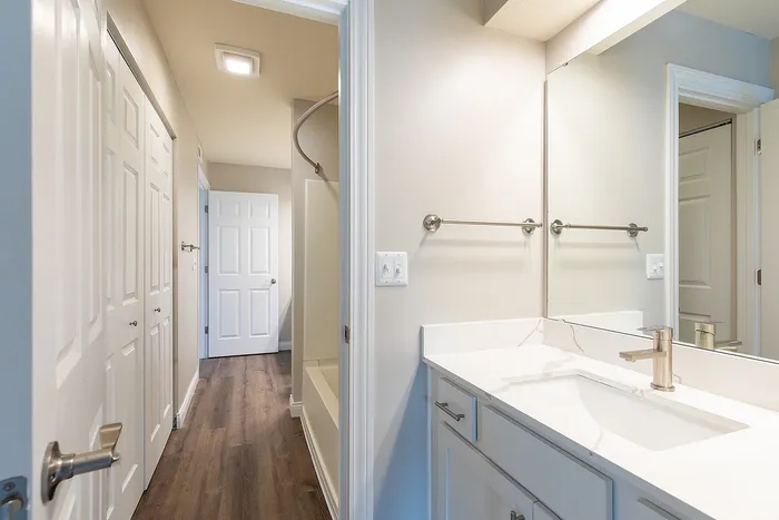 Contemporary bathroom with sleek fixtures, ample storage, and modern lighting in a stylish apartment.