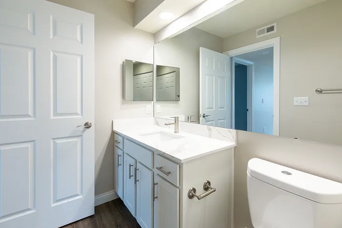 Bright and modern bathroom featuring a sleek marble countertop, stylish vanity, and polished fixtures.
