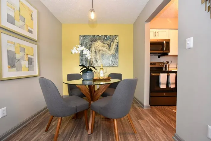 Dining area with overhead lighting and hardwood-style flooring