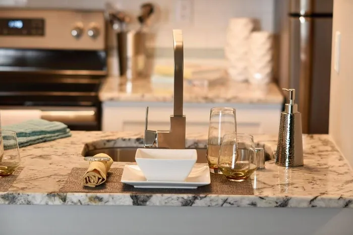 Breakfast bar with granite counters and placemat settings