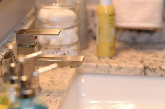 Bathroom details- granite counters and stainless spout