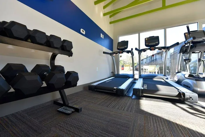 Fully Equipped Fitness Center with treadmills and free weights
