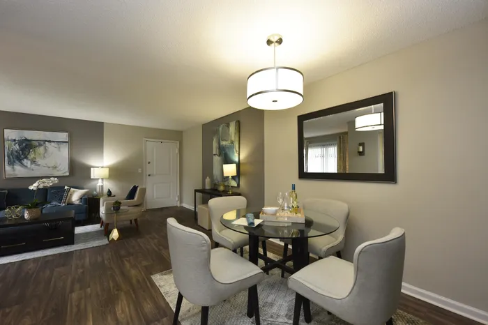 Stylish apartment featuring a cozy living room with modern decor, a glass dining table, and ambient lighting.
