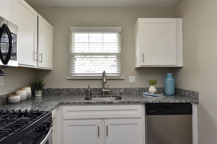 Stylish kitchen interior featuring granite countertops and modern appliances.