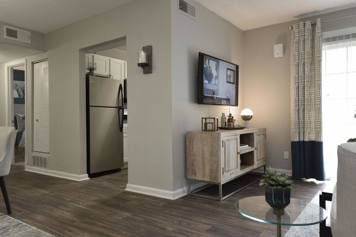 Bright and stylish apartment living space with modern decor and a well-equipped kitchen.
