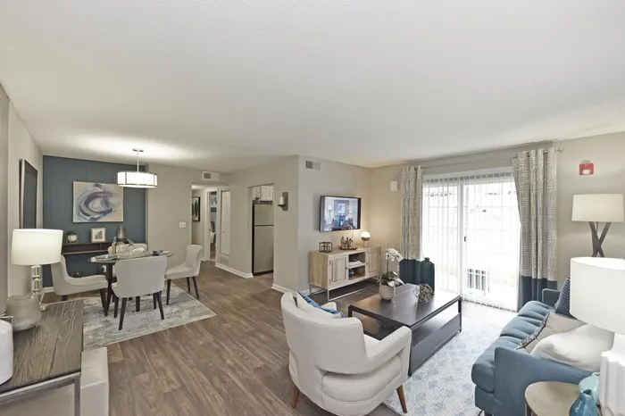 Inviting open-concept living and dining area with modern furniture and natural lighting.