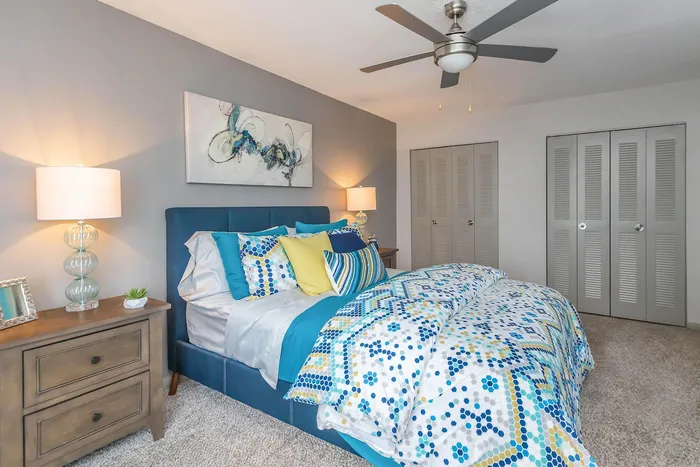 Inviting bedroom with modern decor featuring a plush bed, stylish bedding, and ambient lighting.
