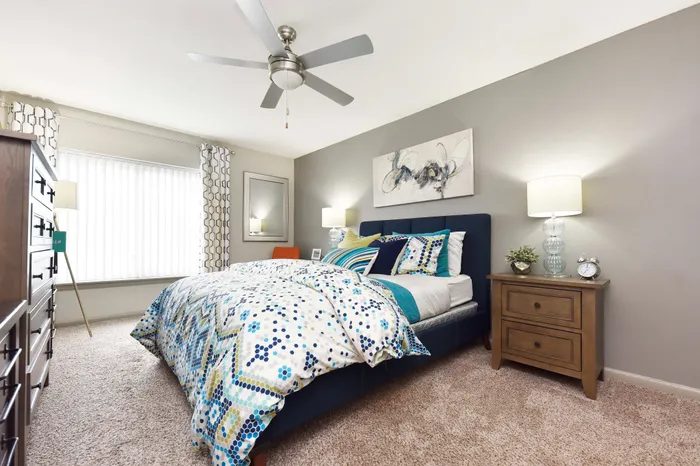 Inviting bedroom with a modern design, featuring a plush bed, stylish decor, and abundant natural light.