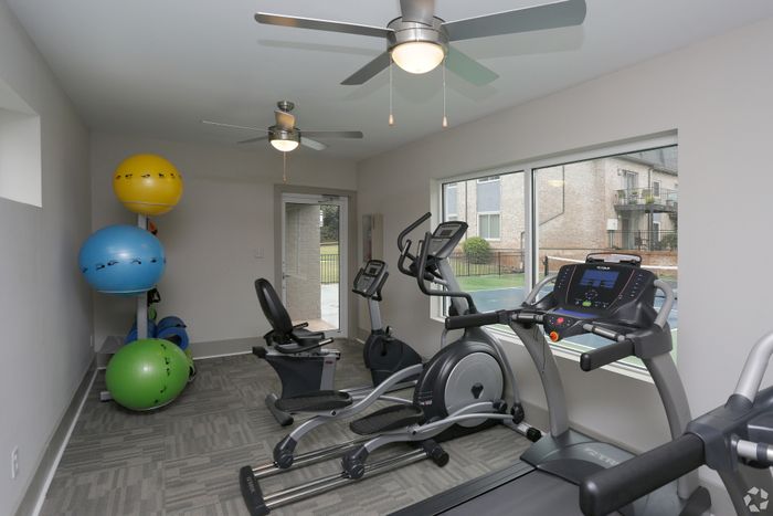 Inviting home gym with exercise equipment and large windows.