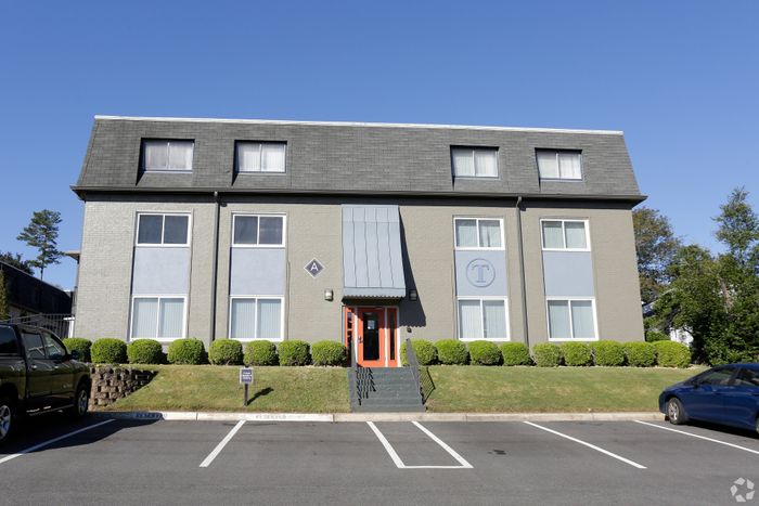 Modern apartment building with a stylish facade and well-maintained landscaping.