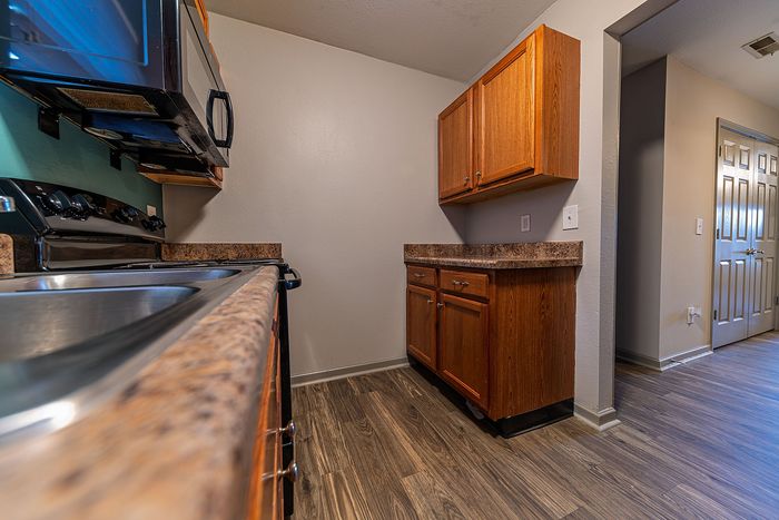 Stylish kitchen with wooden cabinets, sleek countertops, and modern appliances.