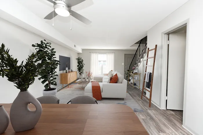 Chic open-plan living room with modern furniture and large windows.