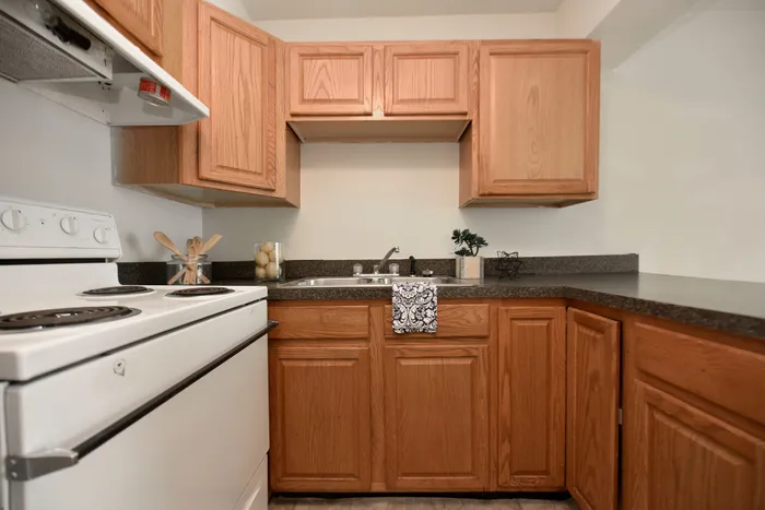 Inviting kitchen with wooden cabinetry, sleek countertops, and modern appliances.