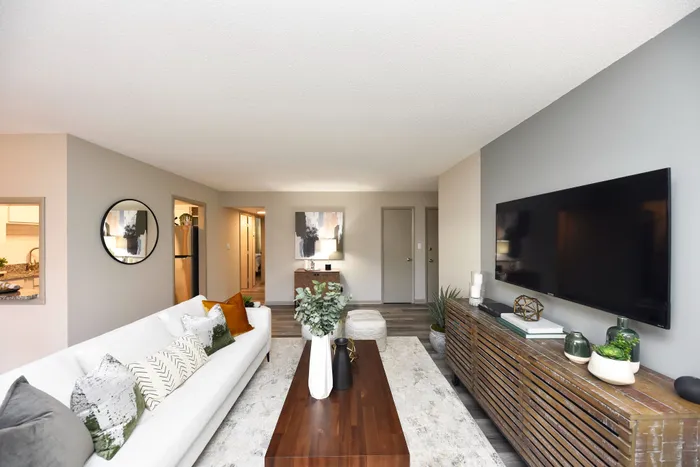 Contemporary living room with sleek decor, modern furniture, and a large wall-mounted TV.