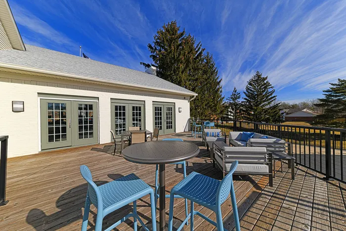 Inviting outdoor patio with modern seating and vibrant blue sky.