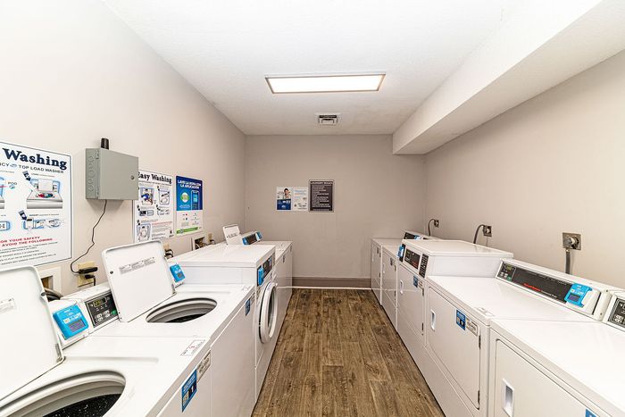 Bright and efficient laundry room equipped with modern washers and dryers, perfect for convenient living.