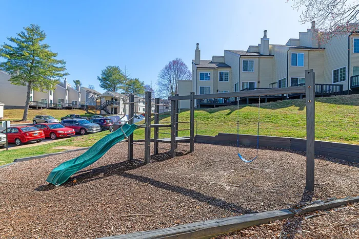 Charming residential complex with modern townhomes, scenic green spaces, and a delightful playground for families.