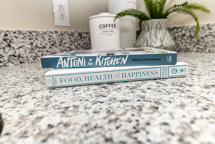 Chic kitchen countertop adorned with inspiring cookbooks, adding a touch of culinary elegance.