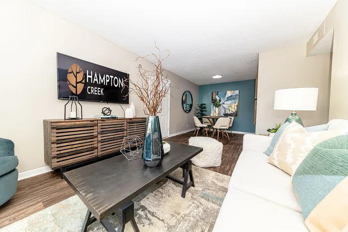 Elegant and inviting living room at Hampton Creek with modern decor, chic furniture, and a cozy dining area.