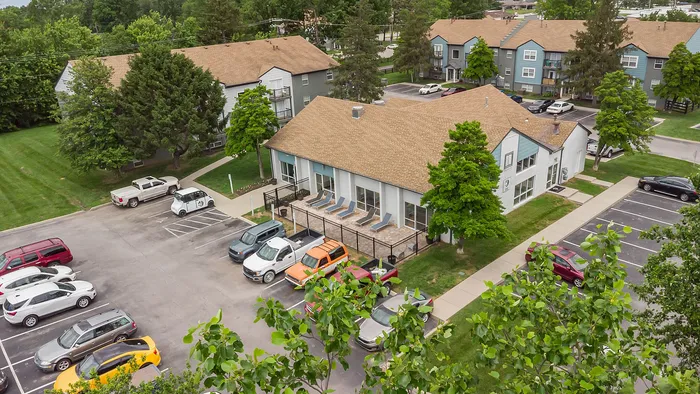 Charming apartment complex with lush greenery, ample parking, and welcoming communal spaces, highlighting a cozy suburban lifestyle.