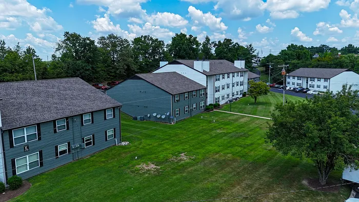 Charming apartment complex surrounded by lush greenery, offering a peaceful suburban setting.