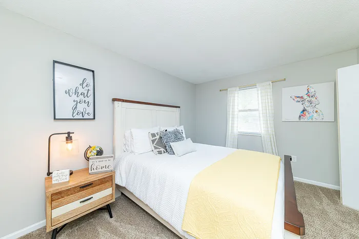 Bright and cozy bedroom with elegant decor, featuring a comfy bed, stylish nightstand, and inspiring wall art.