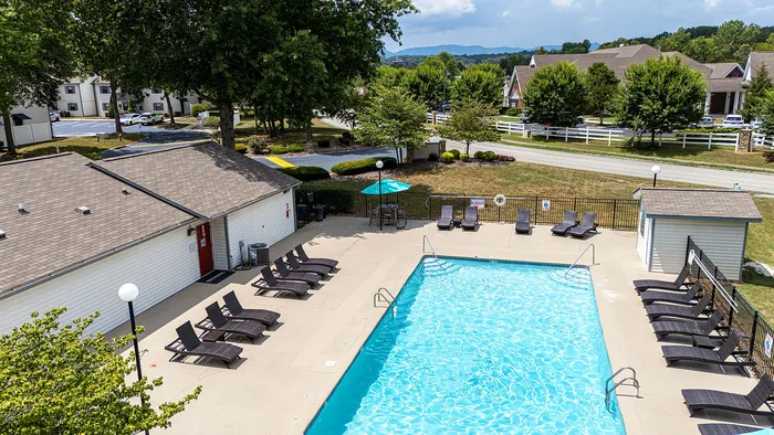 Inviting outdoor pool area with sun loungers and well-maintained landscape, perfect for relaxation and leisure.