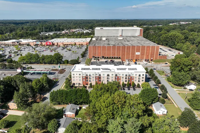Charming urban apartment complex surrounded by lush greenery and close to shopping centers, offering a perfect blend of convenience and serenity.