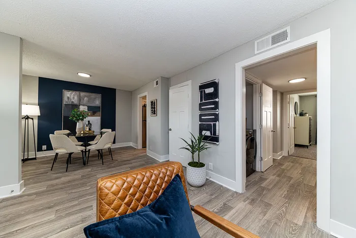 Modern apartment showcasing a stylish dining area with elegant seating, contemporary decor, and sleek wood flooring.