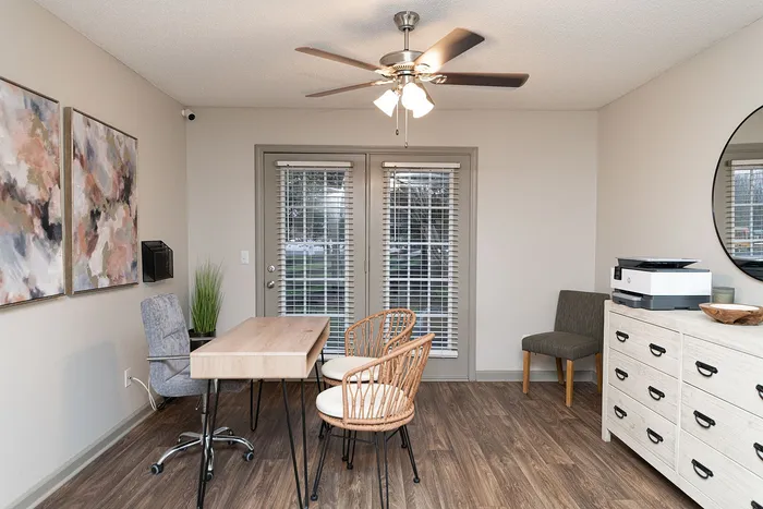 Inviting home office space with modern decor, featuring stylish furniture, vibrant artwork, and large windows for natural light.