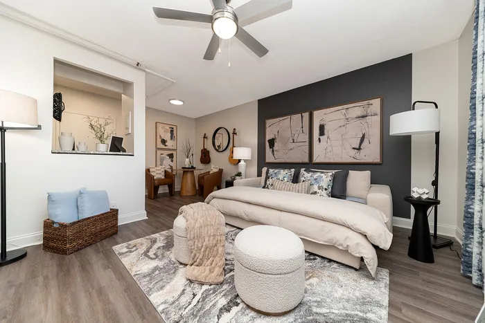 Chic modern living space with elegant decor, featuring abstract art, cozy seating, and contemporary design elements.