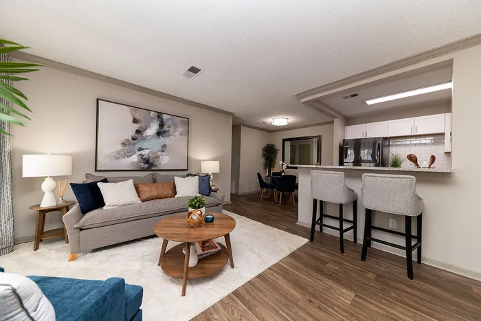 Modern open-concept living space featuring a cozy seating area, stylish breakfast bar, and elegant dining nook, perfect for comfortable living and entertaining.