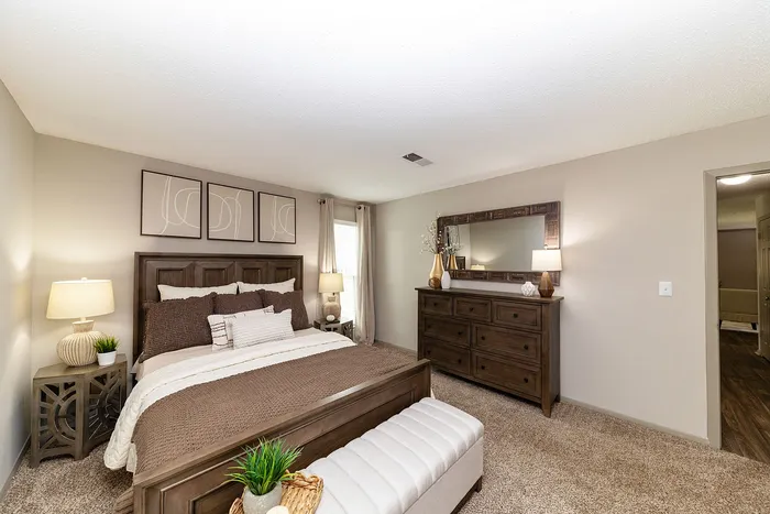 Chic bedroom with elegant decor featuring a plush bed, stylish wooden furniture, and contemporary artwork creating a cozy retreat.