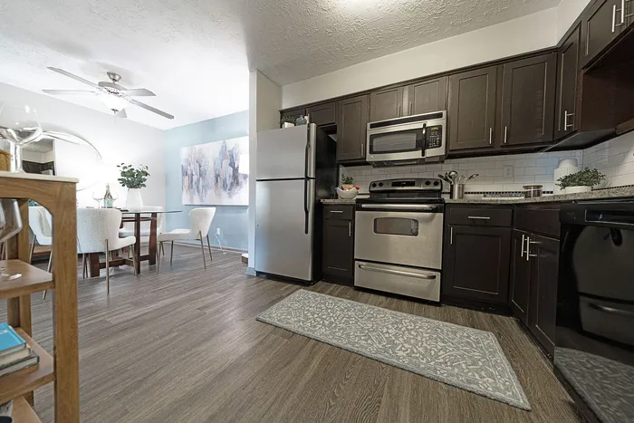 Chic kitchen and dining area with stainless steel appliances, elegant cabinetry, and modern decor.