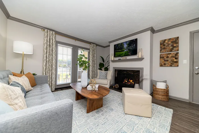 Chic living room with cozy fireplace, stylish decor, and ample natural light.