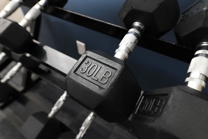 Close-up of sleek 30-pound dumbbells on a sturdy rack, ideal for enhancing home gym aesthetics.