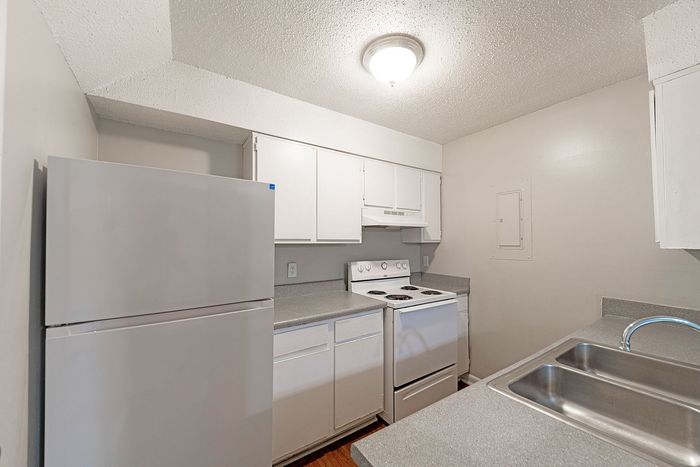 Bright, functional kitchen equipped with modern appliances and sleek cabinetry, offering ample space for culinary creativity.
