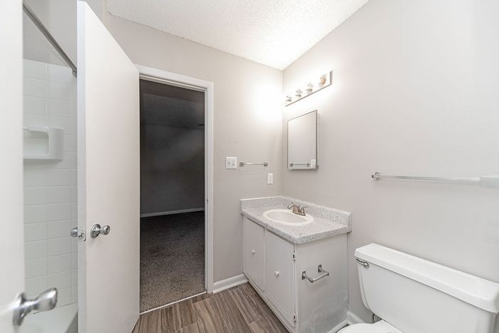 Bright and modern bathroom with sleek white fixtures, a spacious countertop, and elegant lighting for a fresh, inviting space.