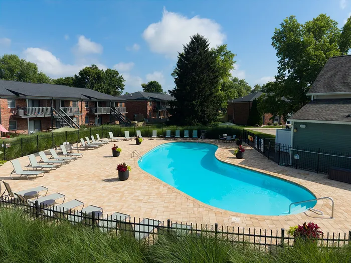 Inviting outdoor pool area surrounded by sun loungers and lush greenery, perfect for relaxation.