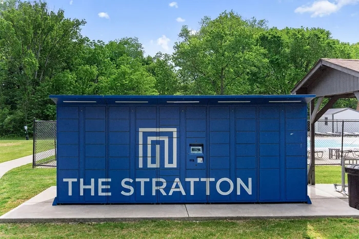 Sleek package locker at The Stratton, nestled in lush green surroundings and convenient outdoor amenities.