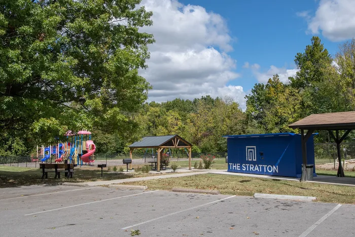 Inviting community park at The Stratton featuring vibrant playground, shaded picnic areas, and lush greenery.
