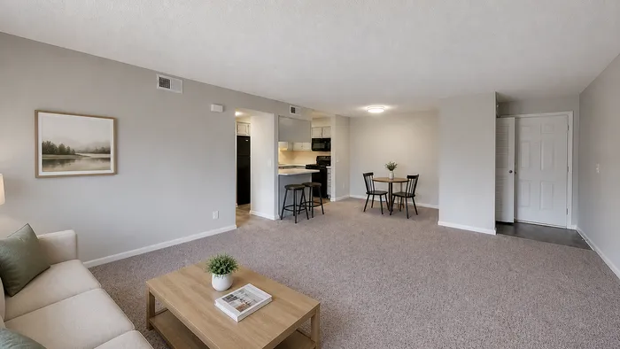 Inviting open-plan living room with cozy seating, stylish coffee table, and a modern dining area, seamlessly connected to a chic kitchen.