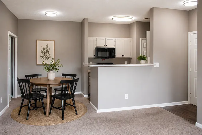 Modern open-plan kitchen and dining space with sleek cabinetry, stylish lighting, and a cozy dining table perfect for gatherings.