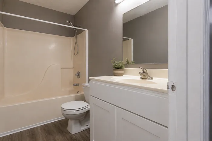 Modern bathroom with sleek fixtures, elegant countertop, and inviting bathtub, perfect for relaxation.