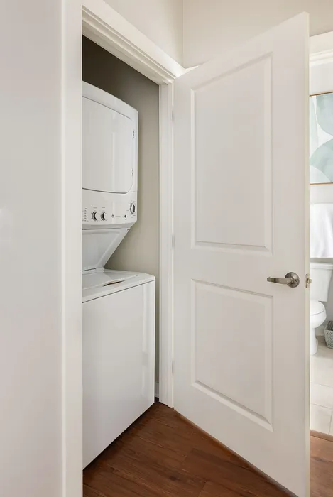 Convenient in-unit laundry with stacked washer and dryer enhances modern apartment living.